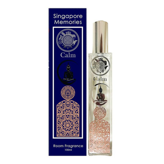 calm scent bottle with buddha and other wellness symbol next to a blue gift box, in front of white background