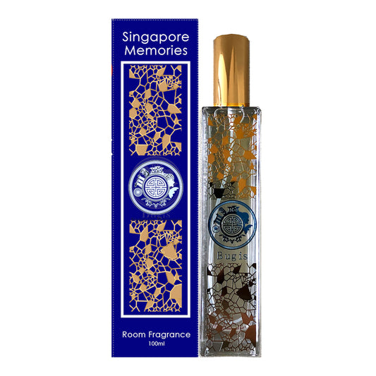 bugis room scent showing gold and silver art work o crystal glass with silver cap. next to a blue color gift box with same metallic design