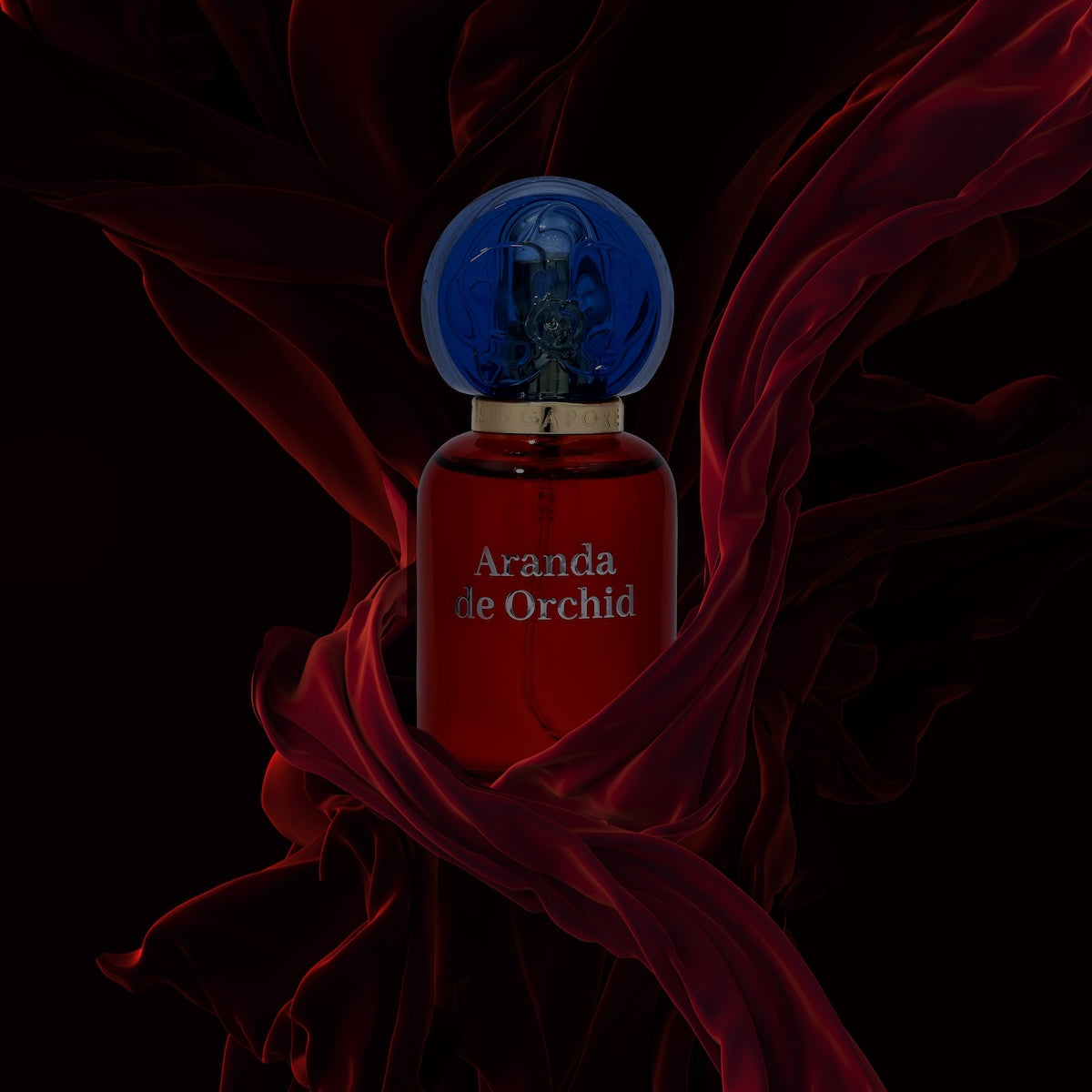 aranda de orchid perfume bottle and flowing red fabric