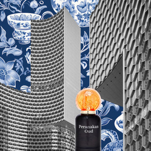 A bottle of peranakan oud scent in front of singapore building with sg batik
