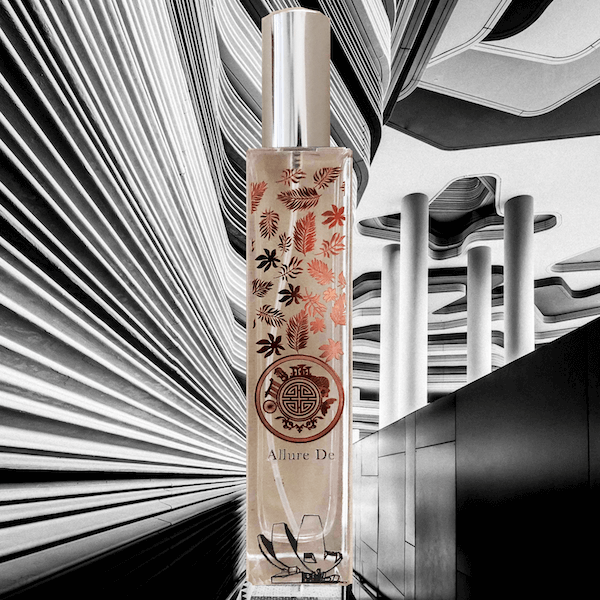 Elegant perfume bottle with intricate floral design set against a monochrome abstract backdrop, perfect for a sophisticated and luxurious fragrance presentation.