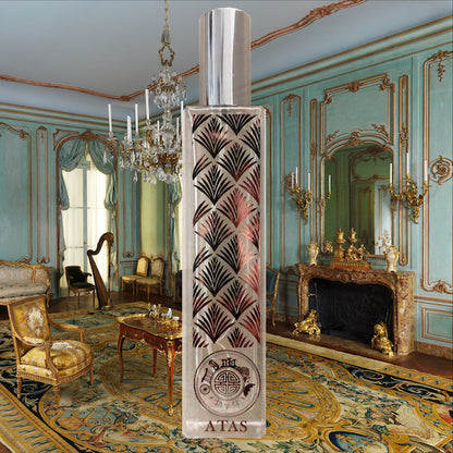 Atas crystal perfume bottle in front of a green lavish home