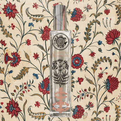 Perfume bottle with text ayurvedic essential and with decorative design on a floral patterned background