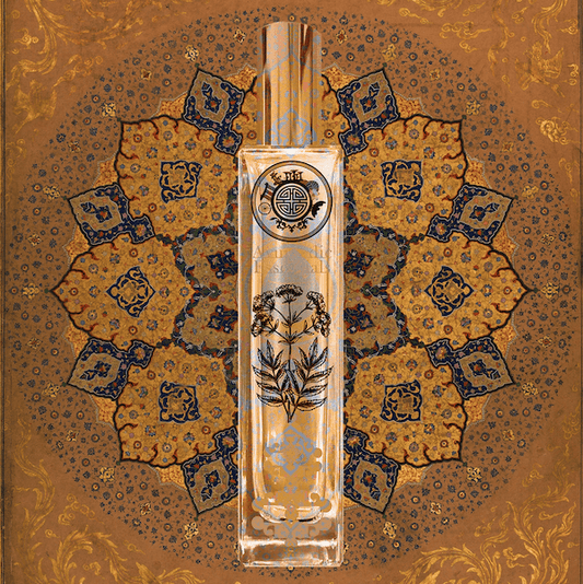 Perfume bottle with ayurvedic essential text and decorative design on a batik patterned background