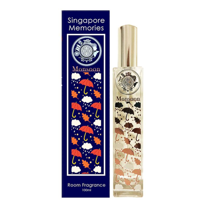 Monsoon room fragrance glass bottle with silver cap next to a blue gift box, in front of white background