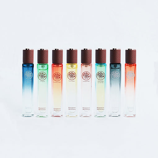 A collection of travel size perfume bottles with a gradient color design, displayed against a white backdrop.