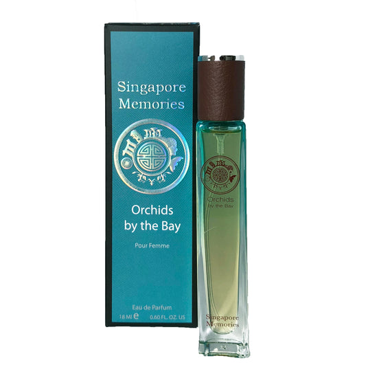 Perfume Singapore Memories , Orchids By The Bay best in blue color next to a gift box showing text orchids by the bay