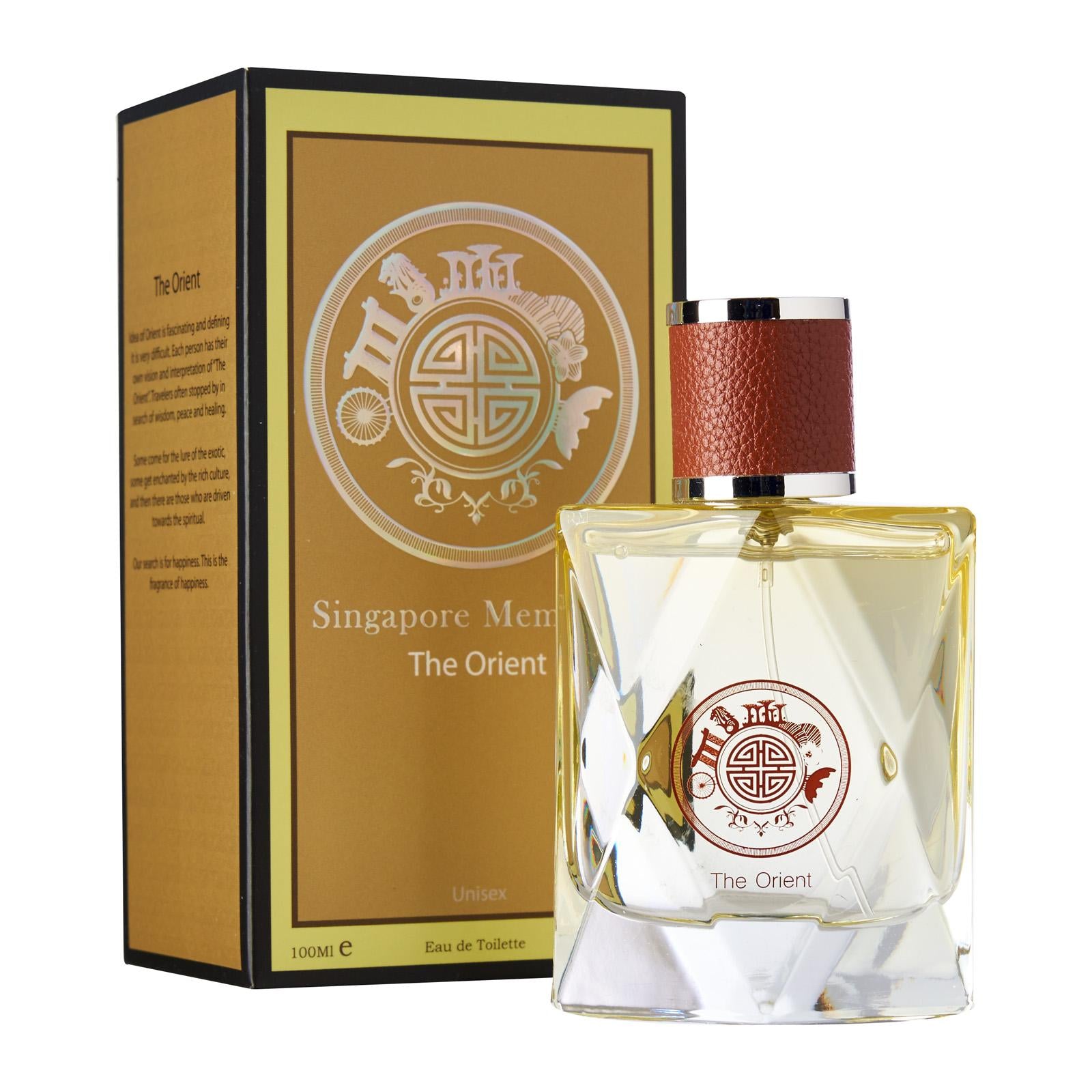 one yellow crystal perfume bottle with orchid scent called the orient in front of a box that says singapore memories perfume