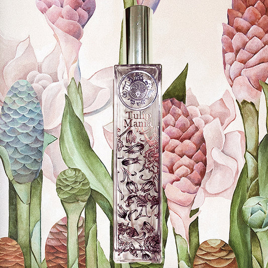 Tulip Mania room fragrance bottle in front of watercolor painting of various plant cones