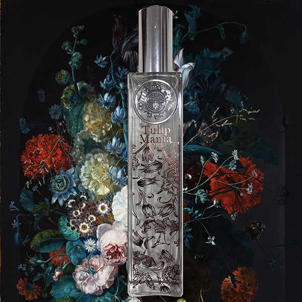 Perfume bottle labeled 'Tulip Manta' surrounded by decorative flowers on a dark background