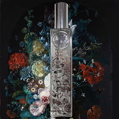Perfume bottle labeled 'Tulip Manta' surrounded by decorative flowers on a dark background