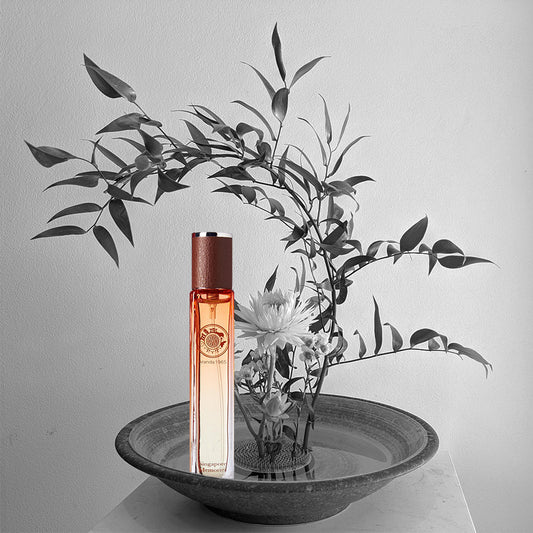Aranda 1965 travel size, perfume bottle in red color with leather cap with plant and orchid flower with singapore ions in the circle logo on the glass bottle