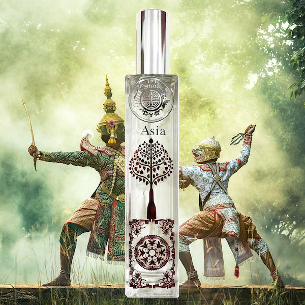 Asia perfume bottle with red elegant design and silver cap, in front of a Balinese painting showing fight between 2 ancient people with beautiful mask