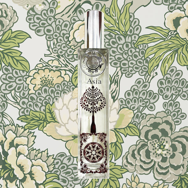 Asia scent bottle with fine red metal work in front of green batik design