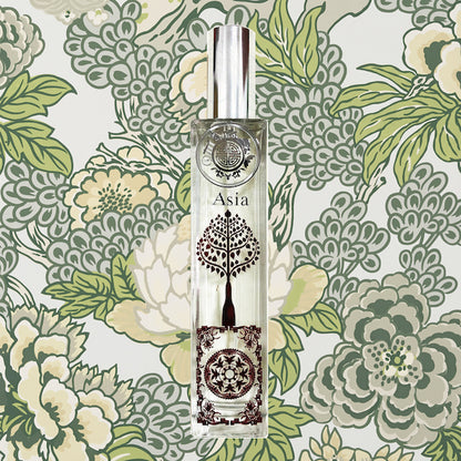 Asia scent bottle with fine red metal work in front of green batik design