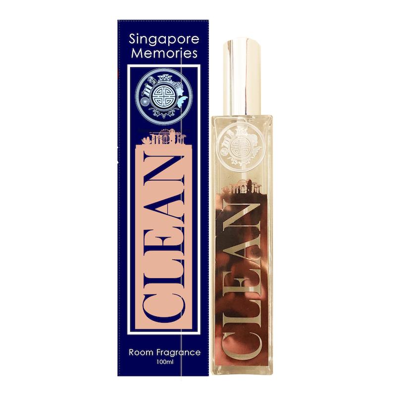 CLEAN singapore room fragrance in rust gold design next to a blue gift box on white background