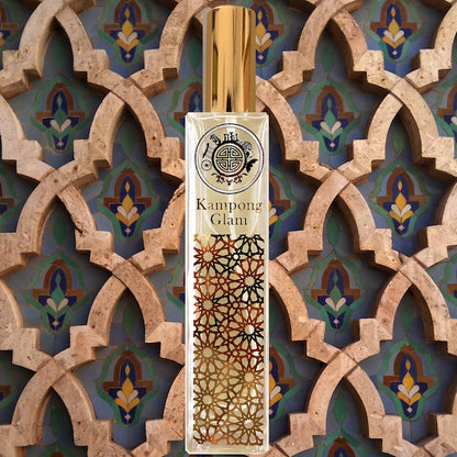 A crystal room fragrance bottle named kampong glam placed in front of arabic design