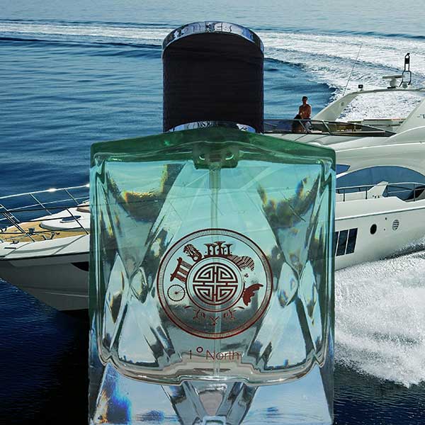 Perfume bottle with a boat in the background. one degree north perfume in singapore