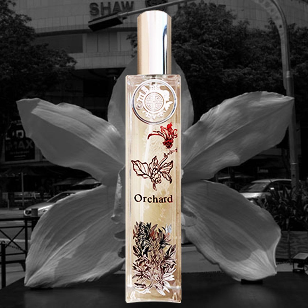 Orchard orchids room fragrance with special red and silver metal design iin front of an ochid sculpture and a corporate building in the background