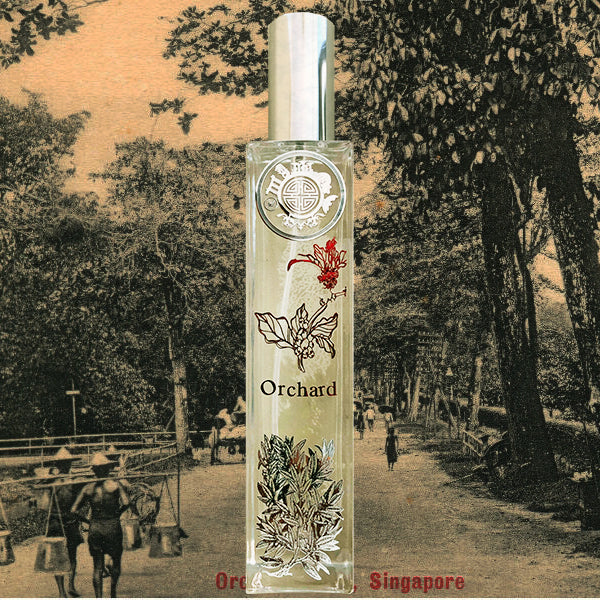 Orchard orchids room fragrance bottle with singapore motif and flower in front . The background is old orchard road 
