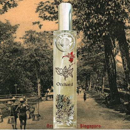 Orchard orchids room fragrance bottle with singapore motif and flower in front . The background is old orchard road 