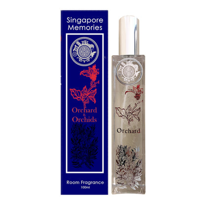 Orchard orchids room fragrance in crystal bottle on the right with floral motif. on the left is blue gift pack in white corporate shoot look