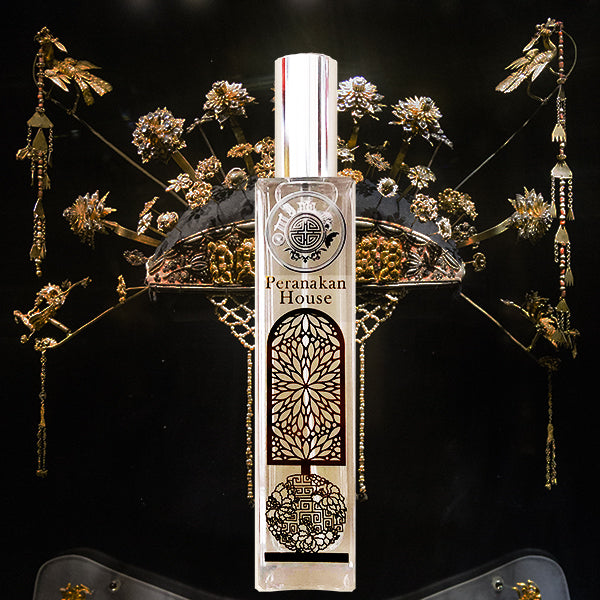 Peranakan house glass & gold bottle in front of elegant head gear in black and gold color