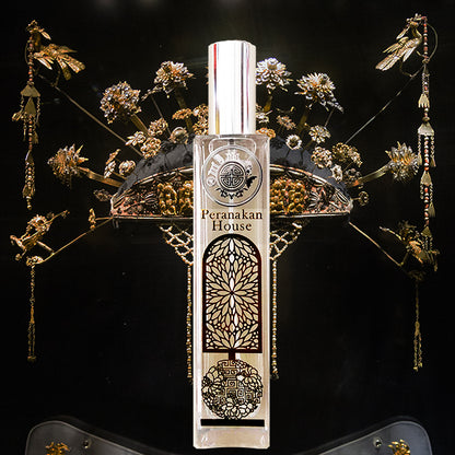 Peranakan house glass & gold bottle in front of elegant head gear in black and gold color