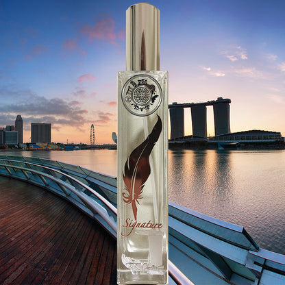 Signature singapore home fragrance with a rust gold leaf symbol and sea and marina bay sands in the background
