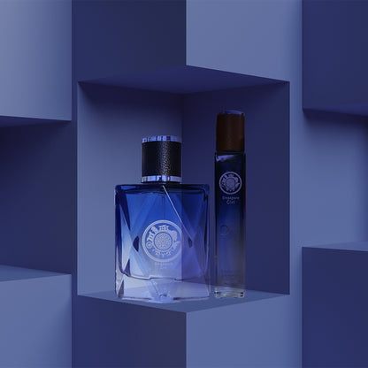 A bottle of Singapore Girl perfume placed on a blue geometric patterned surface, with a smaller travel pack bottle beside it.