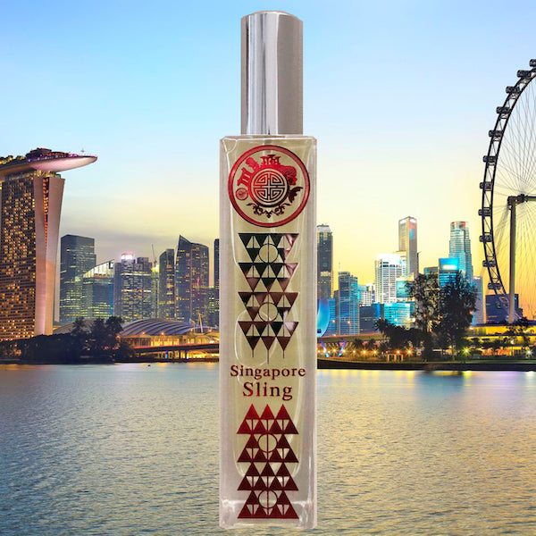A bottle of 'Singapore's Sling' fragrance with a label featuring geometric shapes and a cityscape in the background.