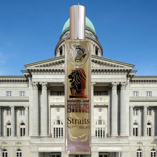 straits settlement bestselling scent in front of a beautiful Singaporean building with stately decor showing Corinthian columns