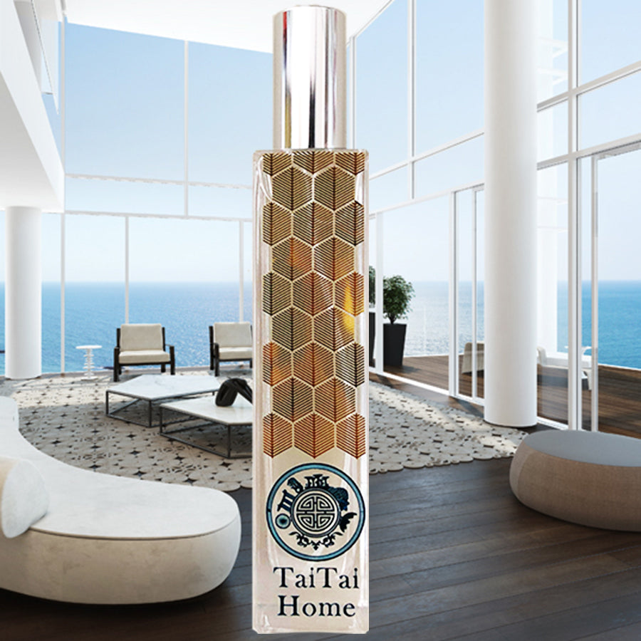 Tai tai home perfume in glass bottle with fine geometric pattern, in front of beautiful home