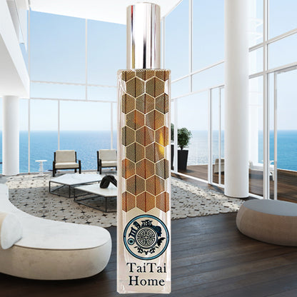 Tai tai home perfume in glass bottle with fine geometric pattern, in front of beautiful home