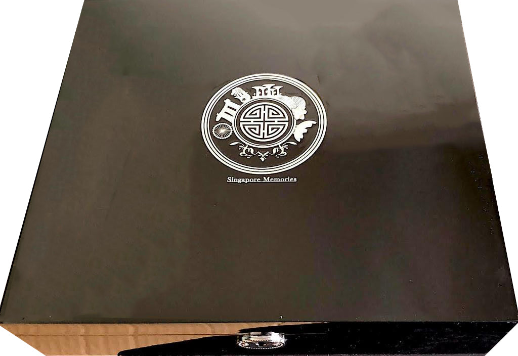 black gift box showing circle logo with singapore motif in premium silver finish